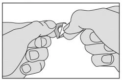 Two hands gently separating a small container or medical blister pack to open it properly
