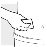 A hand placing a small piece of gauze or swab over the skin in an illustrated section of a medical manual