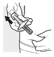 A hand holding a medical device with an exposed spring while the
