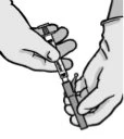 Two hands holding a syringe to connect the