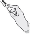 One hand holding a syringe with the needle pointing upward