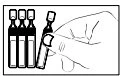 A hand grasping a glass vial next to three similar vials arranged vertically in a row against a white background