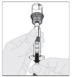 A hand holds a syringe with an upper cap while the