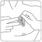Line drawing of a person applying an adhesive patch to the chest with both hands to secure it to the skin
