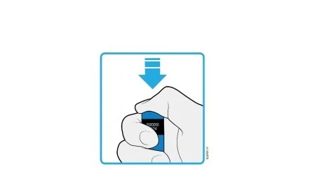 A hand gripping a blue medical device with a blue arrow pointing downward indicating the direction of pressure to apply
