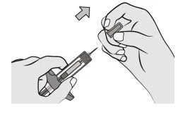 A hand holding a syringe with needle pointing upward