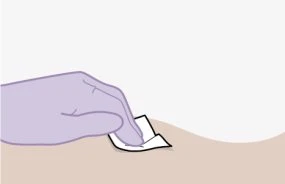 A gloved hand applying a small white adhesive bandage to a light skin surface against a neutral background