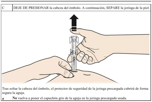 A hand pulling the plunger of the syringe upward to draw the medication