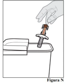A hand holding a medical device with a safety tip and inserting it into a