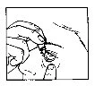 Two hands hold and manipulate a small medical device or container