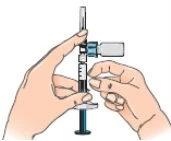 Two hands handling a syringe connected to a glass vial to aspirate liquid through a thin needle