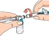 Two hands connecting a syringe to a glass vial using a curved red arrow indicating the rotational movement for attachment