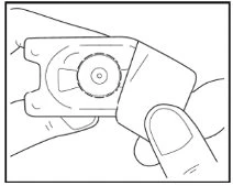 Two hands hold and operate a rectangular medical device with a central circular button for activation