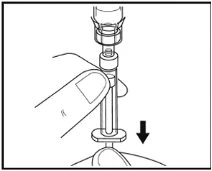 A finger presses the plunger of a syringe downward to inject the contents through the needle