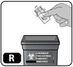 A hand holding a glass vial above a biological waste container with the