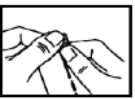 Two hands carefully holding and manipulating a small, thin object or component of a medical administration device