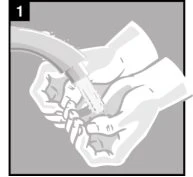 Two hands hold and manipulate a cylindrical medical device with a flexible tube attached at the top against a gray background