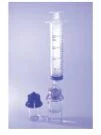 A transparent graduated syringe with plunger placed vertically next to a small glass vial against a light purple background