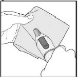A hand holds an open pouch containing a vial of medication ready for use
