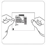 Two hands holding and separating a rectangular instruction leaflet with text and barcode on a white background