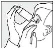 Black and white drawing of a person holding a tilted bottle to instill eye drops into the