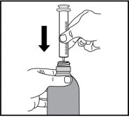 A hand holds a syringe vertically and inserts it downward into the medicine vial to withdraw the content