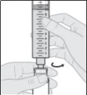 A hand holds a graduated syringe while the