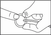Two hands hold and manipulate a small circular device with a thin flexible tube attached to the side