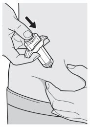 A hand pressing a cylindrical medical device against the skin of the thigh