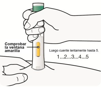 A hand holds a cylindrical medical device pressing it against the skin while the