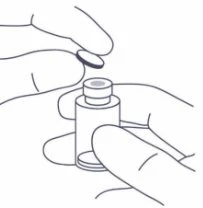 Two hands removing the rubber stopper from a small glass vial for drug preparation