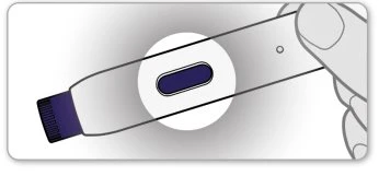 A hand holding an elongated medical device with a circular magnified inset showing a small dark viewing window at the center of the white body