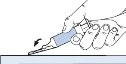 A hand holding a medical device with the needle tilted downward for administration on a flat surface