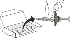 A hand removing a pre-filled syringe from an open cardboard box, indicated by a black curved arrow showing the movement