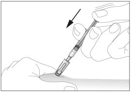 One hand holding a syringe with the