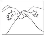 Two hands carefully holding and opening a small rectangular package or wrapper to remove its contents