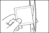 A hand holding a plastic pouch while a pair of scissors cuts its top edge for