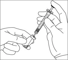 Two hands holding a syringe with a needle to aspirate a liquid from a small glass vial with a rubber stopper