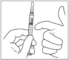 One hand holding a graduated syringe vertically with the