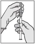 Two gloved hands holding a syringe to prepare or administer the drug precisely