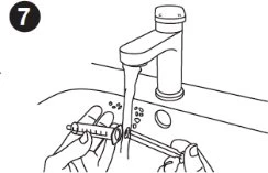 Two hands holding a syringe under a water stream