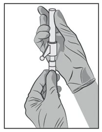 Two gloved hands hold a syringe vertically, featuring a small lateral knob for dose adjustment