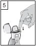 A hand holding an open container while the