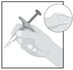 A hand holding a medical injection device with an enlarged detail showing the