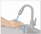 A person's hands washing under a stream of water