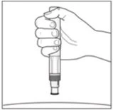 A hand holding vertically an injection pen medical device ready for