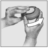 Two hands holding a circular medical device and a white arrow indicating clockwise rotation for the