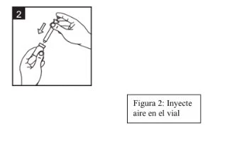 A hand holding a vial while the