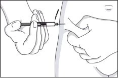 One hand holding a syringe and inserting the