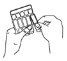 Two hands removing a single vial from a glass blister pack containing multiple vials for drug preparation